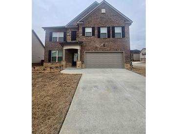 Two-story brick home with attached garage and landscaping at 3462 Hawthorn Farm Blvd, Loganville, GA 30052