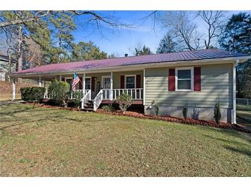 Ranch style home with a covered porch and landscaped yard at 52 Jennifer Ln, Carrollton, GA 30116