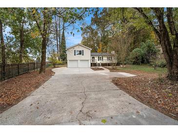 Ranch home with two-car garage and a large driveway at 2088 E Cherokee Dr, Woodstock, GA 30188