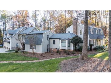 Gray house with gray roof, multiple dormers, and landscaped lawn at 315 Brandenburgh Cir, Roswell, GA 30075