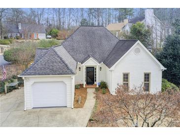 Charming single-Gathering home with white brick exterior and attached garage at 620 Oakledge Nw Dr, Marietta, GA 30060