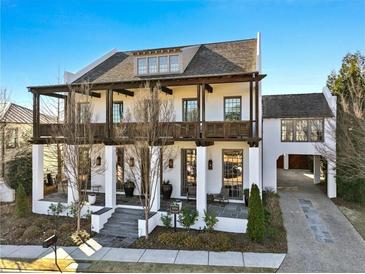 Two-story white home with dark brown accents, balconies, and a covered porch at 6870 Colfax Ave, Cumming, GA 30040