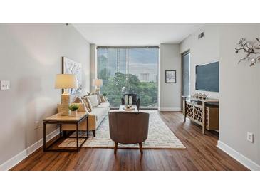 Spacious living room with hardwood floors and city views at 2795 Peachtree Ne Rd # 703, Atlanta, GA 30305