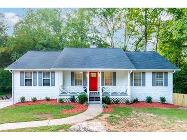 Charming white house with gray shutters, red door, and landscaped yard at 185 Bob White Dr, Stockbridge, GA 30281