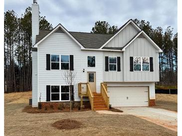 Charming two-story home with white siding, black shutters, and an attached two-car garage at 482 Charleston Pl, Villa Rica, GA 30180