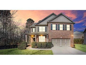 Two-story brick home with a large front yard and attached garage at 2336 Morgan Estate Dr, Buford, GA 30519