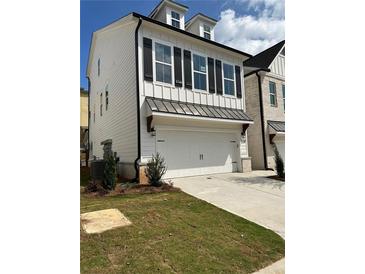 Charming two-story home featuring a white exterior, black shutters and trim, and an attached two-car garage at 1250 Winterhaven Dr, Cumming, GA 30041