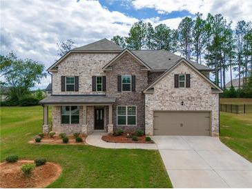 Two-story brick home with a large front yard and driveway at 816 Graeme Dr, Mcdonough, GA 30252