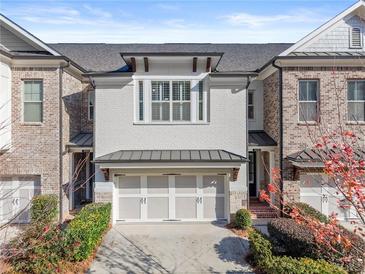 Stunning brick front exterior of townhome with 2-car garage at 3939 Glenview Club Ln, Duluth, GA 30097