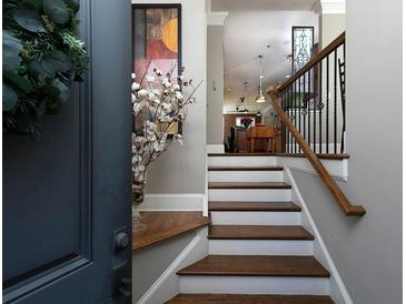 Inviting entryway with hardwood stairs, decor, and a view into the living spaces at 62 Emerson Hill Sq, Marietta, GA 30060