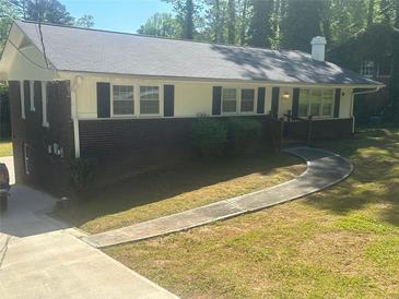 Brick ranch house with a large yard and walkway at 2362 Maxwell Sw Dr, Atlanta, GA 30311