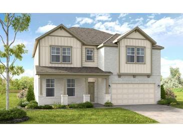 Two-story home with light brick and vinyl siding, a two-car garage and landscaping at 525 Nolden Trl, Dacula, GA 30019