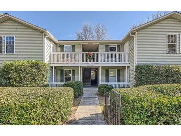 Inviting exterior of a two-story condo building with well-manicured landscaping at 1945 Brian Way, Decatur, GA 30033