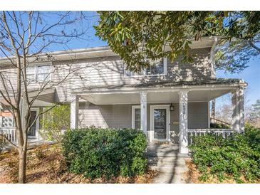 Gray two-story house with front porch and landscaping at 2698 Farmstead Se Rd, Smyrna, GA 30080