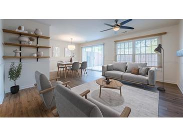 Bright living room featuring hardwood floors, natural light, and neutral paint tones at 2698 Farmstead Se Rd, Smyrna, GA 30080