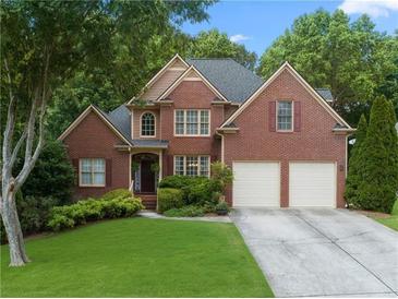 Brick two-story house with two-car garage and landscaped lawn at 156 Vine Creek Dr, Acworth, GA 30101