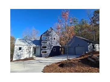 Modern two-story home with attached two-car garage and landscaped yard at 160 Cedarwood Ln, Roswell, GA 30075