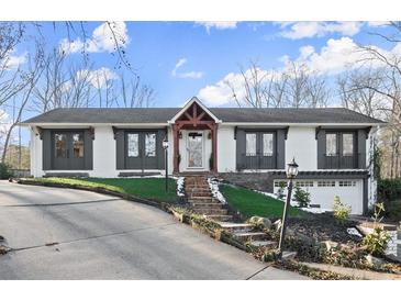 Stunning ranch home with gray and white exterior, stone steps, and attached garage at 2148 Allgood Rd, Marietta, GA 30062