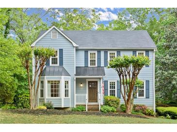 Charming two-story home with blue siding, a bay window, and a well-manicured front yard at 3616 Longfellow Trl, Marietta, GA 30062
