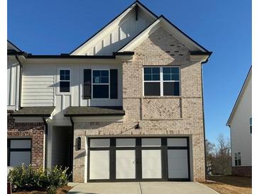Charming brick and siding home featuring a two-car garage and well-maintained landscaping at 226 Depot Landing Rd # 56, Auburn, GA 30011