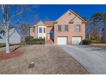 Brick two-story house with attached two-car garage and manicured landscaping at 3643 Southland Ne Dr, Buford, GA 30519