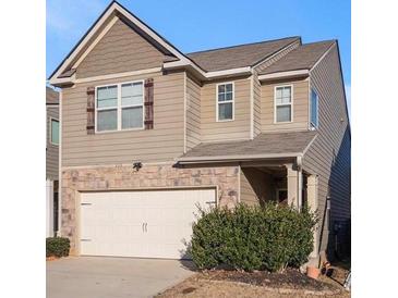 Charming two-story home with a stone-accented facade and attached two-car garage at 529 Dasheill Ln, Atlanta, GA 30349