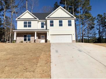 Charming two-story home with a brick-accented porch and a pristine two-car garage at 195 Ridgecrest Way, Stockbridge, GA 30281