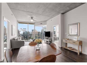 Modern dining area with wooden table and chairs, offering city views at 860 Peachtree Ne St # 2605, Atlanta, GA 30308