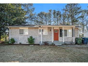 Ranch style home with red front door and landscaped yard at 2040 Forrest Park Se Rd, Atlanta, GA 30315