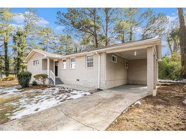 Ranch style home with carport and landscaped yard at 3395 Springlake Dr, Decatur, GA 30032
