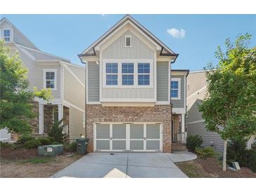 Brick and siding two-story home with a two-car garage at 667 Crosshaven Dr, Marietta, GA 30066