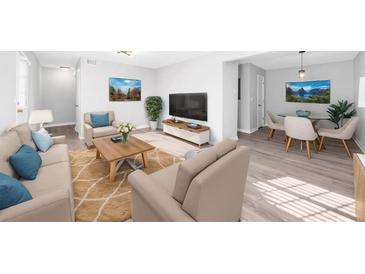 Bright living room showcases neutral tones, wood floors, and comfortable seating at 3091 Colonial Way # E4, Chamblee, GA 30341