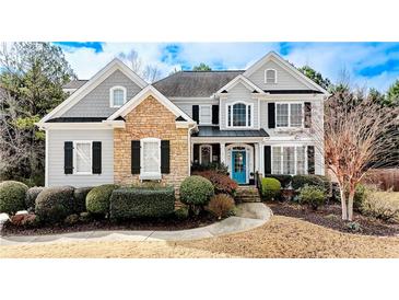 Two-story house with stone accents and a landscaped yard at 8919 Elina Rose, Douglasville, GA 30134