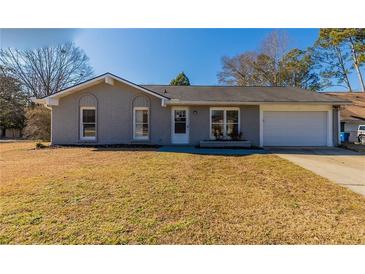 Newly renovated ranch home with gray brick exterior and a 1-car garage at 100 Glace Rd, Atlanta, GA 30349