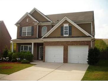 Two-story brick home with a large driveway and landscaped yard at 1710 Rutland Pass Dr, Lawrenceville, GA 30045