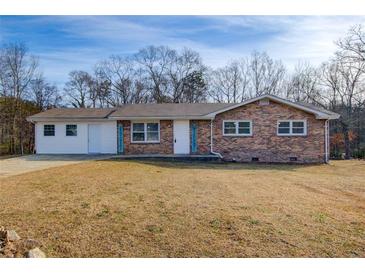 Brick ranch house with attached garage and spacious yard at 24 Echo Ridge Dr, Powder Springs, GA 30127