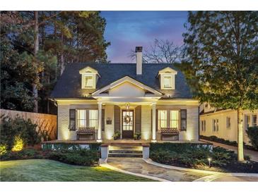 Charming brick home with a welcoming front porch and landscaping at 566 Church Ne St, Marietta, GA 30060