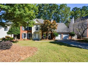 Brick house with two-car garage and manicured lawn at 658 Wolfs Bane Nw Dr, Acworth, GA 30102