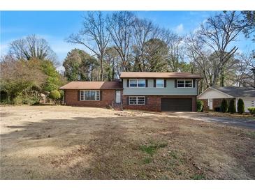 Ranch style home with attached garage and large yard at 4418 Palm Springs Dr, Atlanta, GA 30344