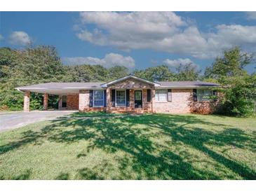 Brick ranch house with carport and spacious yard at 3130 Mars Hill Rd, Acworth, GA 30101