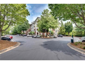 Apartment building with lush landscaping, ample parking and beautiful tree lined entry at 1965 Nocturne Dr # 1209, Alpharetta, GA 30009