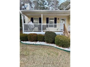 Ranch home with front porch, landscaping, and satellite dish at 41 Lady Savannah Dr, Dallas, GA 30157