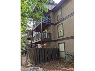 Multi-level building with private balconies and a fenced backyard at 710 River Run Dr, Atlanta, GA 30350
