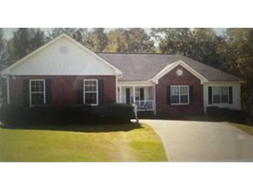 Brick ranch home with landscaped yard and driveway at 155 Vinnys Way, Covington, GA 30014