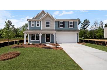 Charming two-story home features a front porch, a two-car garage, and a beautifully landscaped yard at 126 Cherry Glen Way, Euharlee, GA 30145