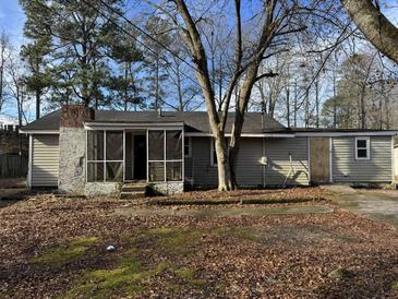 Ranch home with screened porch and mature trees at 3965 Pecan Rd, Loganville, GA 30052