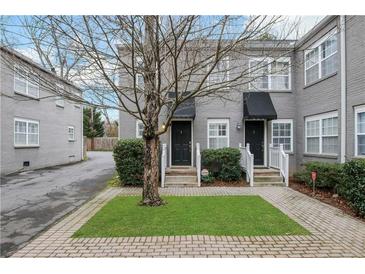 Gray duplex with black awnings, landscaping, and brick walkways at 285 Oxford Ne Pl # 4, Atlanta, GA 30307