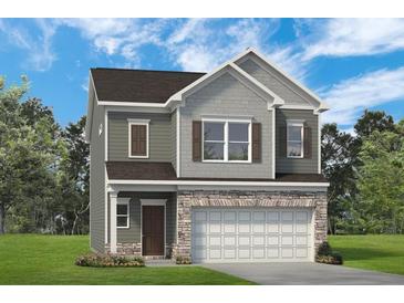 Two-story home with gray siding, stone accents, and a two-car garage at 726 Shetland Trl, Cartersville, GA 30121