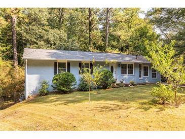 Ranch style home with blue painted brick exterior and landscaped yard at 2849 Crescendo Nw Dr, Atlanta, GA 30318
