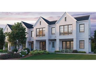 Three-unit townhome building, white brick exterior, landscaping, and a grassy lawn at 1341 Grannysmith Trce # 45, Brookhaven, GA 30319